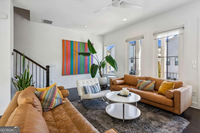 living room with dark hardwood / wood-style floors and ceiling fan