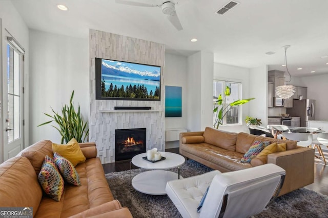 living room with a fireplace, hardwood / wood-style floors, and plenty of natural light