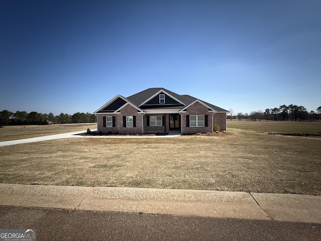 craftsman-style home with brick siding and a front yard