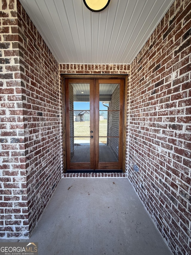 property entrance with french doors and brick siding