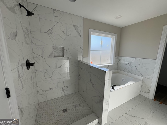 bathroom featuring separate shower and tub and tile walls