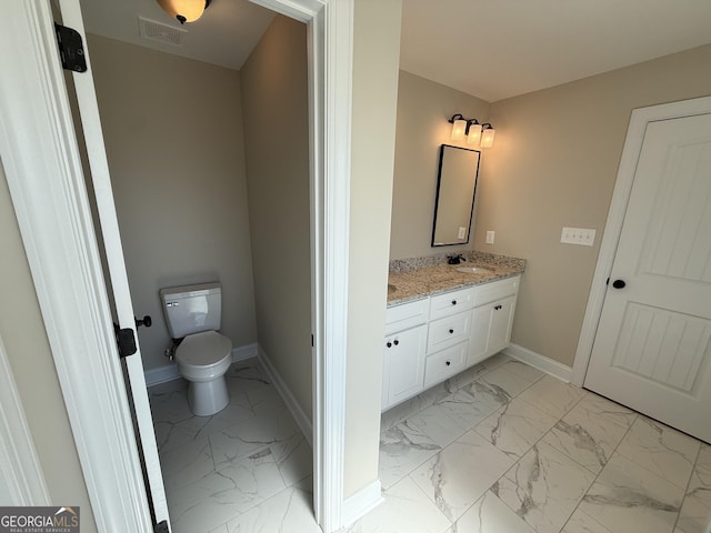 full bathroom featuring baseboards, visible vents, toilet, marble finish floor, and a sink