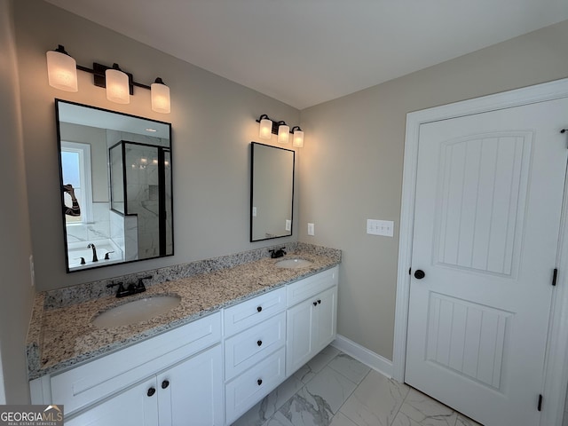 full bathroom with marble finish floor, a sink, a shower stall, and double vanity