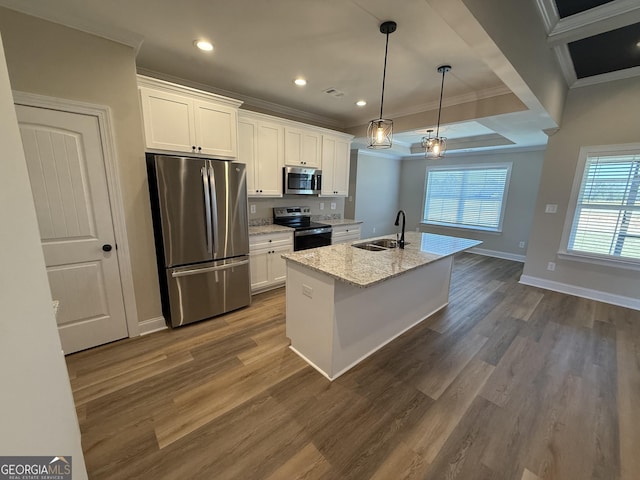 kitchen with an island with sink, white cabinetry, appliances with stainless steel finishes, and a sink