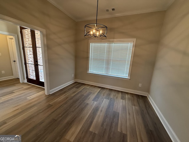 unfurnished dining area with dark wood-style flooring, visible vents, crown molding, and baseboards