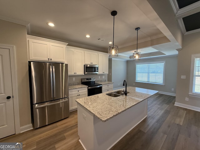 kitchen featuring a center island with sink, white cabinets, appliances with stainless steel finishes, light stone countertops, and a sink