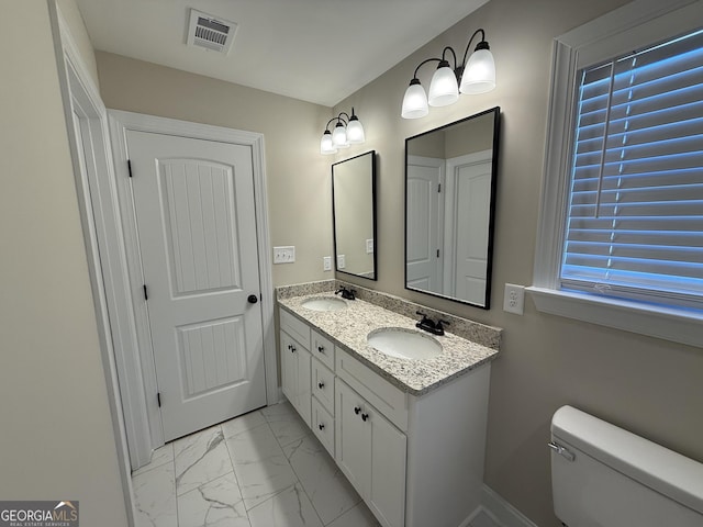 bathroom with marble finish floor, visible vents, a sink, and toilet