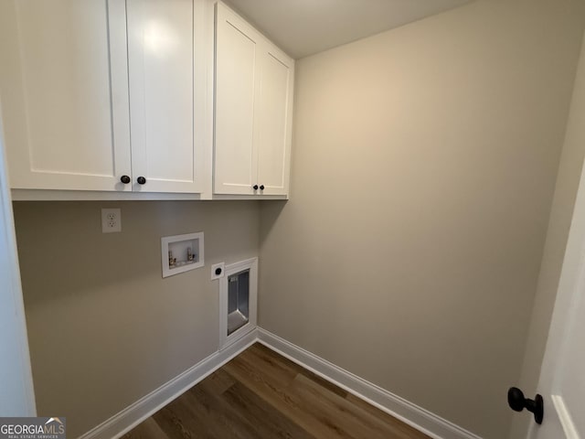 clothes washing area featuring hookup for a washing machine, cabinet space, dark wood-type flooring, hookup for an electric dryer, and baseboards