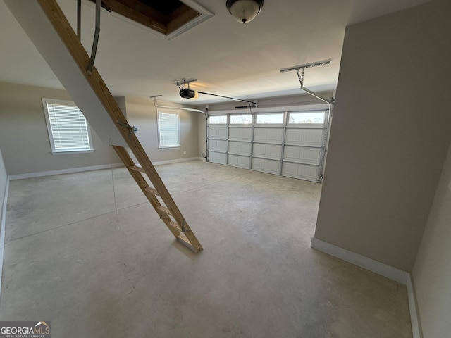 garage with baseboards and a garage door opener