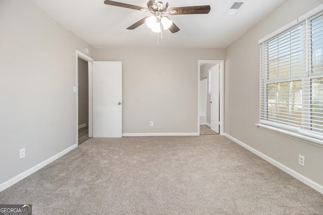 unfurnished bedroom featuring ceiling fan and light carpet