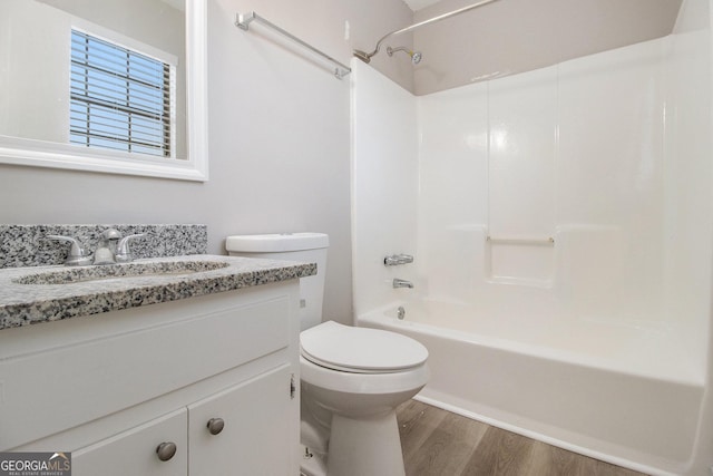 full bathroom with vanity, wood-type flooring, bathtub / shower combination, and toilet