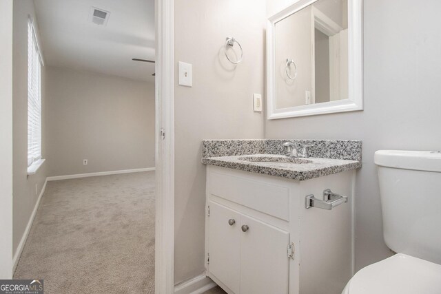 bathroom with vanity and toilet