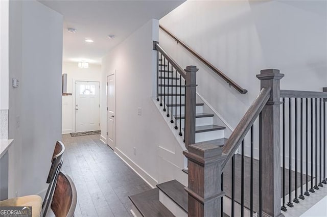 stairway featuring wood-type flooring