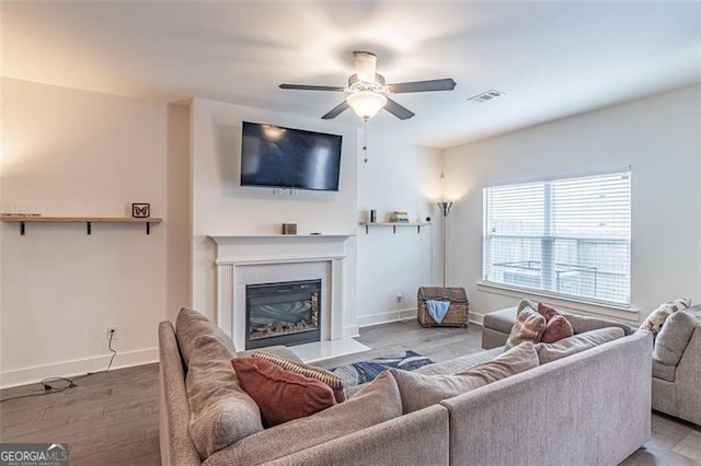 living room featuring ceiling fan and hardwood / wood-style flooring