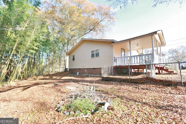 rear view of house featuring a deck