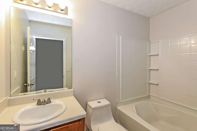 full bathroom featuring vanity, a textured ceiling, toilet, and washtub / shower combination