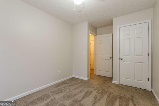 unfurnished bedroom featuring carpet flooring and a textured ceiling