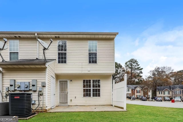 rear view of house featuring a lawn, a patio area, and central air condition unit