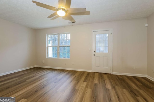 foyer entrance featuring dark hardwood / wood-style floors, ceiling fan, and a textured ceiling