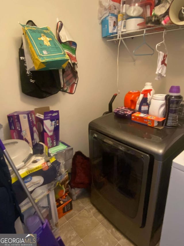 laundry room featuring light tile patterned floors and washer and dryer