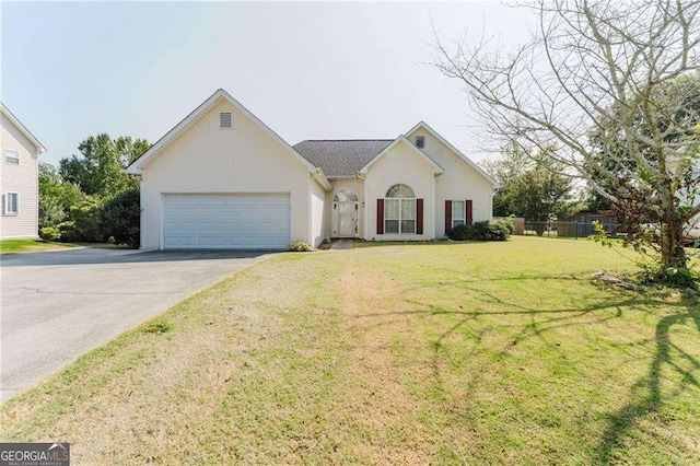 view of front of property with a front yard and a garage