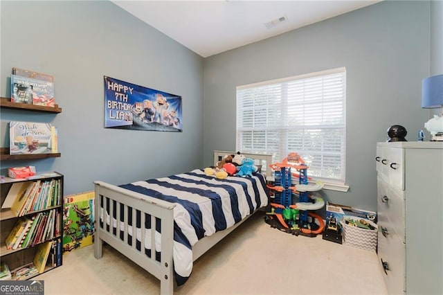 bedroom featuring multiple windows and light carpet