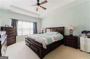 bedroom featuring ceiling fan and a tray ceiling