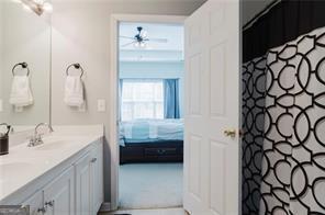 bathroom with vanity and ceiling fan