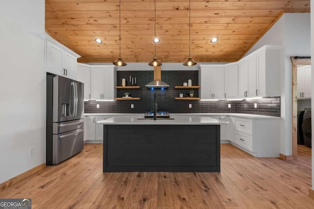 kitchen featuring pendant lighting, light hardwood / wood-style floors, white cabinets, and stainless steel fridge with ice dispenser