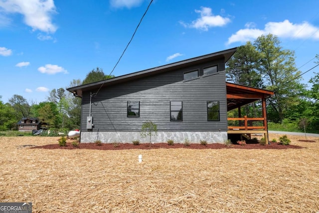 view of property exterior featuring a wooden deck