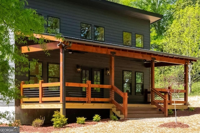 back of house with ceiling fan and a wooden deck