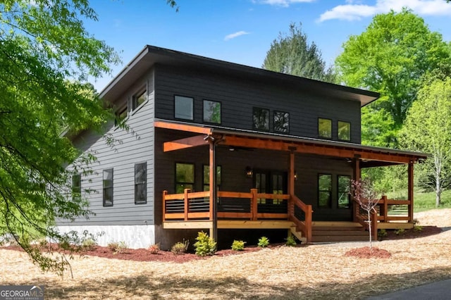 view of front of home with covered porch and french doors