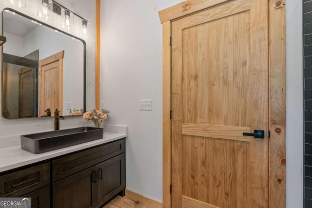 bathroom featuring hardwood / wood-style floors and vanity