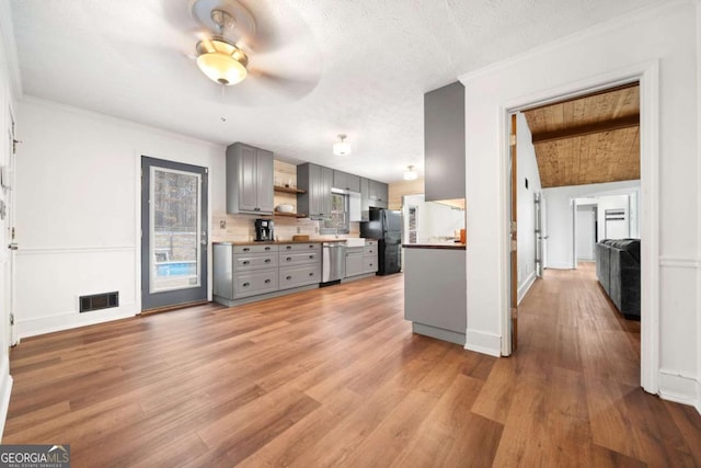 kitchen featuring gray cabinetry, black refrigerator, stainless steel dishwasher, crown molding, and light wood-type flooring