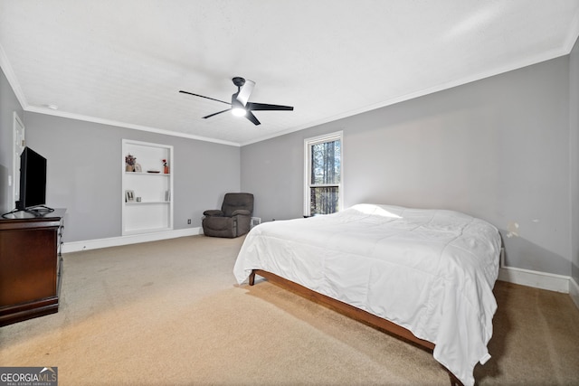 bedroom with carpet floors, crown molding, and ceiling fan