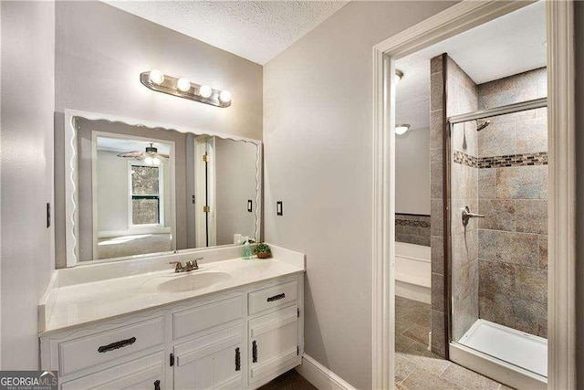 bathroom with an enclosed shower, vanity, and a textured ceiling