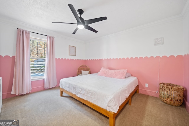 carpeted bedroom featuring a textured ceiling, ceiling fan, and ornamental molding