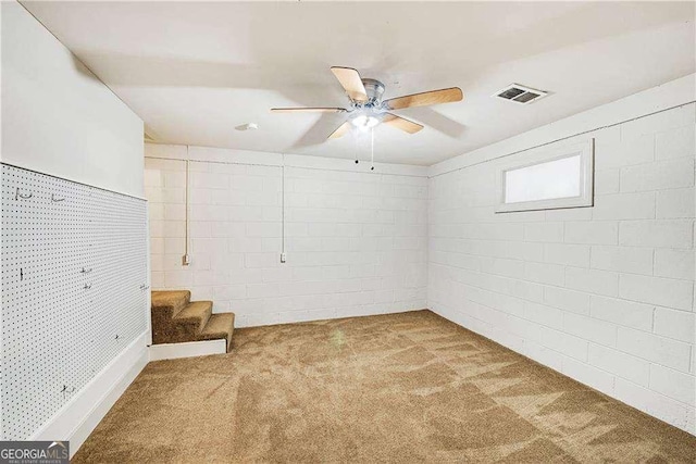 basement featuring ceiling fan and carpet floors