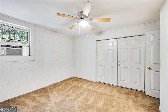 unfurnished bedroom featuring light carpet, a closet, ceiling fan, and cooling unit