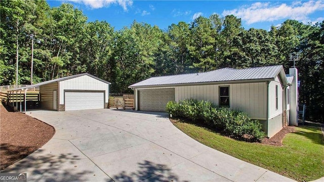 view of front of house with a carport, a garage, and an outbuilding