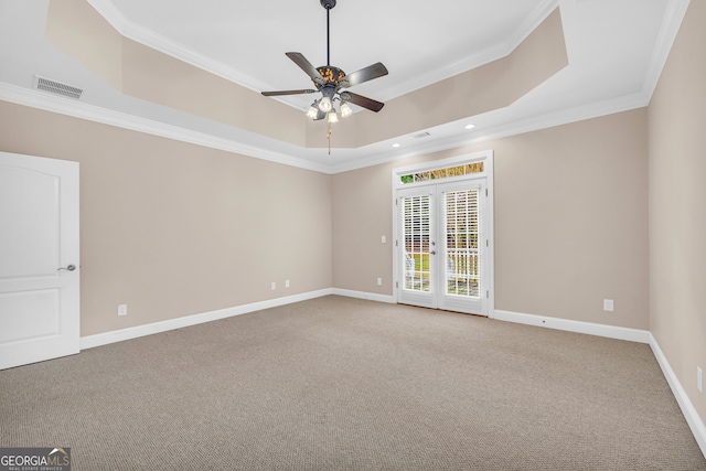 spare room with french doors, ornamental molding, a tray ceiling, ceiling fan, and carpet floors