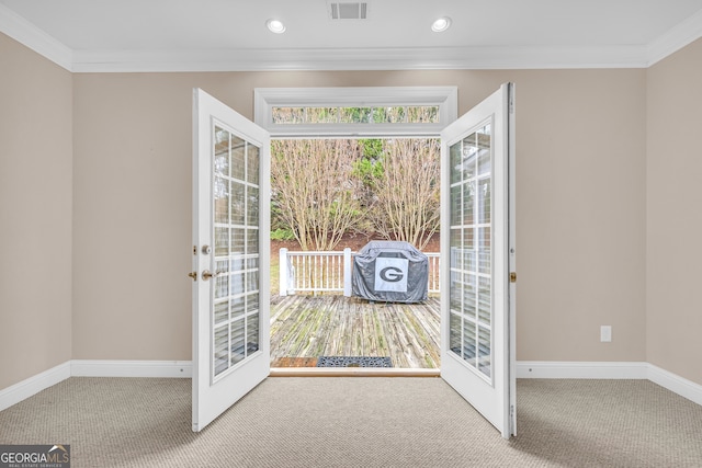 doorway to outside featuring carpet flooring, french doors, and crown molding