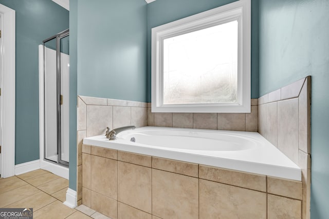 bathroom with tile patterned floors and shower with separate bathtub