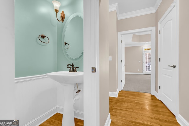 bathroom featuring crown molding and wood-type flooring