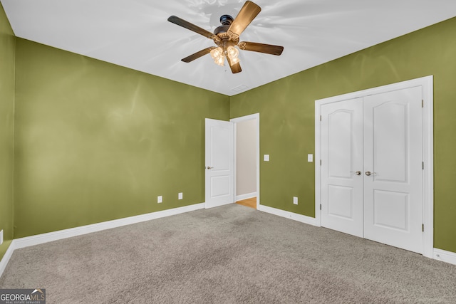 unfurnished bedroom featuring carpet flooring, a closet, and ceiling fan