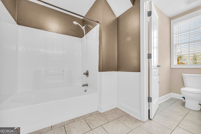 bathroom featuring tile patterned floors,  shower combination, and toilet