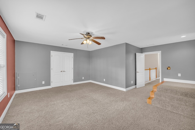 carpeted empty room with ceiling fan