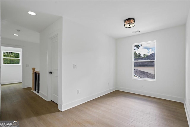 spare room featuring wood-type flooring