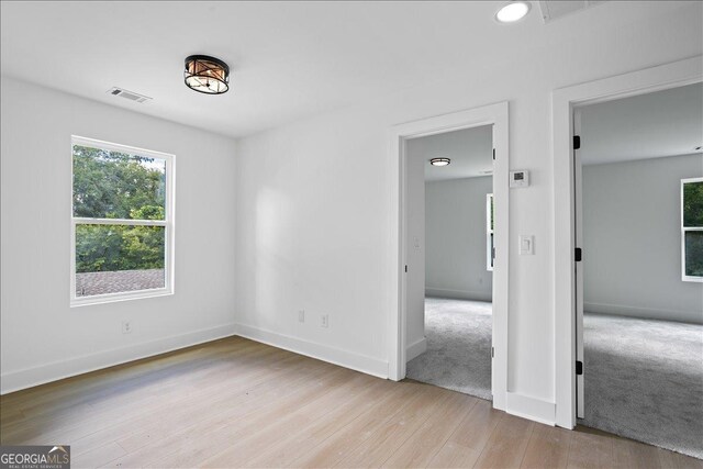 spare room with light wood-type flooring