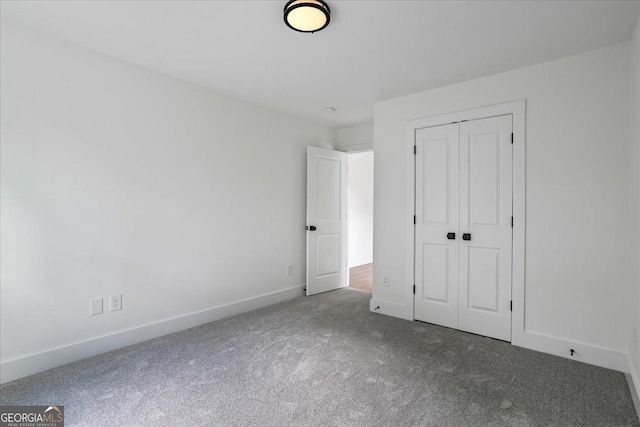 unfurnished bedroom with carpet floors and a closet